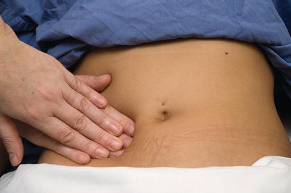 Deep palpation during abdominal examination.