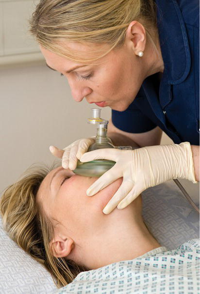 Mask with one‐way valve over patient's nose and mouth and rescuer giving breath.