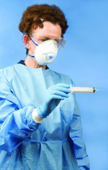 Nurse wearing personal protective equipment (PPE) for the administration of ribavirin.